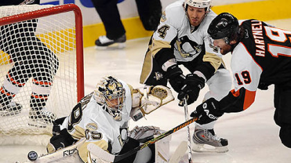 Penguins goalie Marc-Andre Fleury just gets a piece of the puck on Flyers Scott Hartnell.