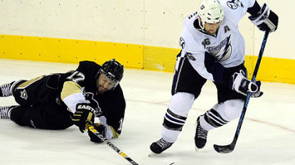 Penguins' Petr Sykora can't get his stick on the puck as the Lightning's Jason Ward races down the ice in the second period of last night's preseason NHL hockey.