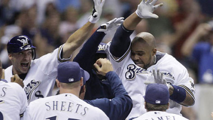 The Brewers' Prince Fielder, right, is congratulated at home after hitting a walkoff two-run home run in the ninth inning of yesterday's game against the Pirates in Milwaukee. The Brewers won 7-5.