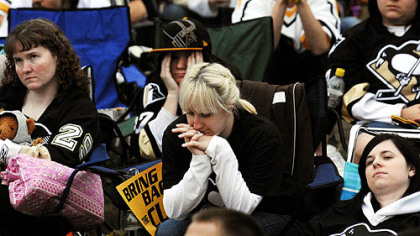 Erin Kolenda, center, and other Penguins fans feel the pain.