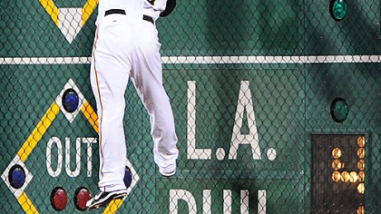 Right fielder Jason Michaels tries to make a leaping catch at the wall on a ball hit by the Cubs' Derrek Lee last night.