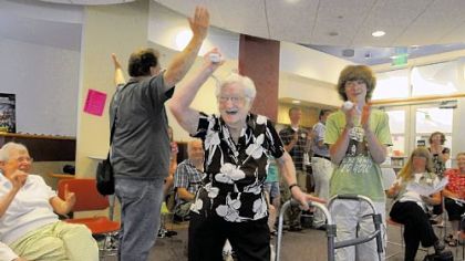 Virginia Kotow cheers as she scores a strike in a game of Wii bowling.