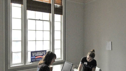 Sarah Bell, left, and Elizabeth Baribeau, campaign volunteers from San Francisco, work at Hillary for President headquarters on Smithfield Street yesterday as part of the "All Voices Count" women's tour, which is spending two days going from Pittsburgh to Carlisle.