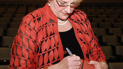 Sportswoman of the year, Pitt women's basketball coach Agnus Berenato, autographs a basketball that is to be auctioned off as part of the Dapper Dan 
dinner festivities last night at the David L. Lawrence Convention Center, Downtown.