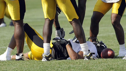 Hines Ward is slow to get up after taking a hard hit from teammate Anthony Smith.