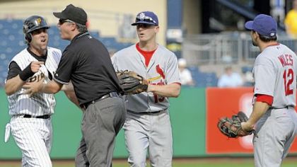 The Pirates' Doug Mientkiewicz is kept away from the Cardinals' Aaron Miles in the eighth inning.