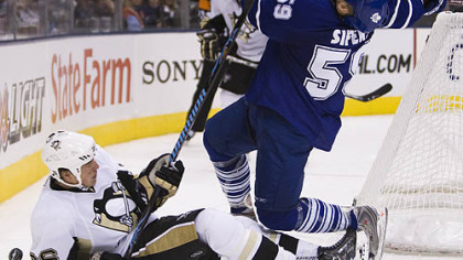 Toronto Maple Leafs defenseman Jaime Sifers, right, gets a high stick from the Penguins' Ruslan Fedotenko during third period preseason NHL action yesterday in Toronto. Fedotenko received a penalty on the play.