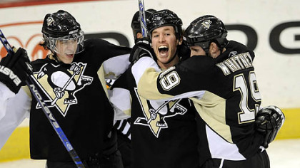Ryan Malone capped a three-goal comeback in the third period to beat the Panthers last night at Mellon Arena. Converging on him are Evgeni Malkin, left, and Ryan Whitney.