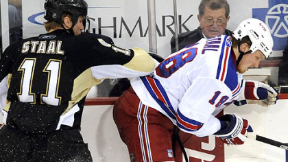 Penguins Jordan Staal gets a hit along the boards on his brother Marc Staal in the second period Sunday at Mellon Arena.