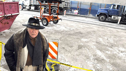 Sol Gross stands in front of his building at 625 Stanwix St., where the street and sidewalks are coated with a layer of dirt from the North Shore Connector light-rail tunnel project.