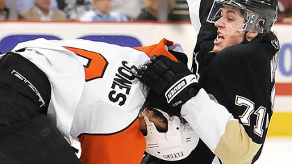 Penguins Evgeni Malkin is taken down by the Flyers Randy Jones in the second period