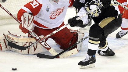 Adam Hall reaches to shoot the puck for his team's third goal.