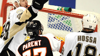Adam Hall knocks the puck away from the Flyers' Ryan Parent.