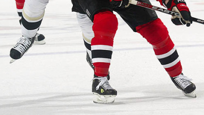 Jarkko Ruutu, left, attempts to get around New Jersey's Vitaly Vishnevski Tuesday night in Newark, N.J.
