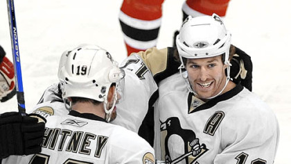 Ryan Whitney and Petr Sykora celebrate with Ryan Malone (12) after Malone scored against the Devils in the first period last night.