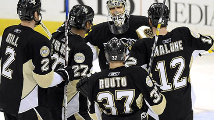 Penguins Marc-Andre Fleury gets congratulated by teammates after defeating the Flyers Sunday.