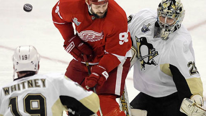 Penguins goalie  Marc-Andre Fleury makes a save in front of Red Wings Tomas Holmstrom.