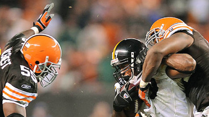 Steelers running back Willie Parker is tackled by Andra Davis.