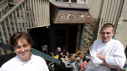 Girasole's executive chef Jennifer Girasole, left, and head chef Chris Corimski sit at the restaurant's entrance and outside dining area in Shadyside.