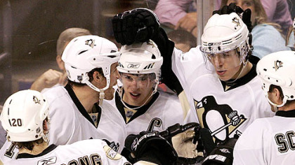 Sidney Crosby is mobbed after giving the Penguins a 2-0 lead in the second period last night against Florida.