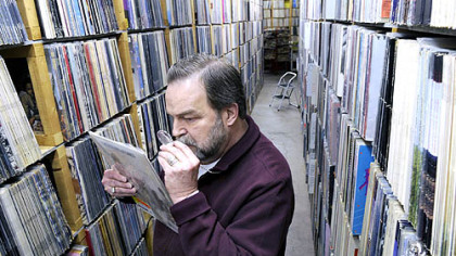 Paul Mawhinney examines a Rolling Stones album he said is worth  $10,000 at Record Rama in Ross.