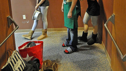 Even an entrance way becomes a dressing room for Kelly Reyholds (left),18, Gene Vereamner (center), 17, being helped with his costume by  Kaitlyn Black, 18. All are seniors from Chartiers Valley High SChool performing in "Siegfried."