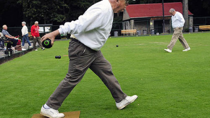 Jack Phillips winds up his back swing during a Wednesday lawn bowling match and cookie fest.