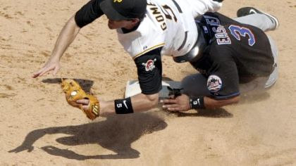 Pirates' Chris Gomez flies over Mets' Damion Easley after getting him out at second base.