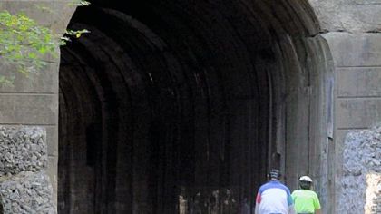 Cyclists cruise into the Greers Tunnel along the Montour Trail in Peters.