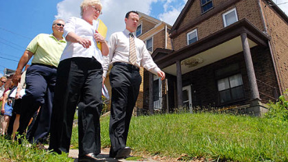 Judy Hackel, middle, president of Allentown Community Development Corp., walks alongside Mayor Luke Ravenstahl, right, during a neighborhood sweep of Allentown on Thursday.  Citations were given out throughout the sweep.