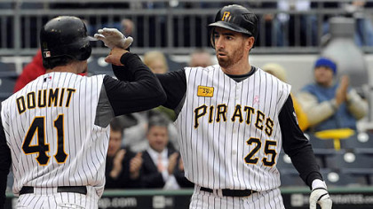 Adam LaRoche is congratulated by teammate Ryan Doumit after hitting a two-run home run against the Braves in the eighth inning today in the first game of a doubleheader. The Pirates won, 5-0.