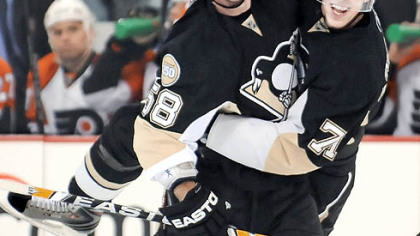 The Penguins' Evgeni Malkin, right, celebrates with Kris Letang, who scored the winning goal yesterday in a 4-3 victory against the Philadelphia Flyers at Mellon Arena.