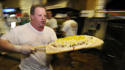 Former Mineo's Pizza House employee Regis Dusch, is back helping cook up pies during the 50th Anniversary event at the Squirrel Hill insitutution.