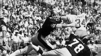The Browns' Greg Pruitt finds Loren Toews and Dwight White waiting for him before he gets out of the backfield in this 1976 game photo.
