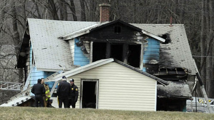 Authorities gather near the house that was the scene of fatal fire in Brockway.