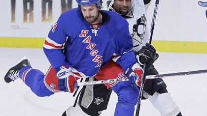 New York Rangers' Jason Strudwick, left, battles to clear the puck against Pittsburgh Penguins' Georges Laraque in the first period during Game 4 of an NHL Eastern Conference semifinal hockey playoff series Thursday, May 1, 2008 at Madison Square Garden in New York.