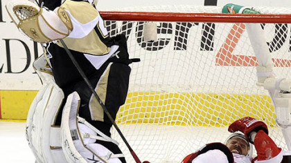 Tomas Holmstrom ends up in the net as he's injured behind Penguins goalie Marc-Andre Fleury in the third period.