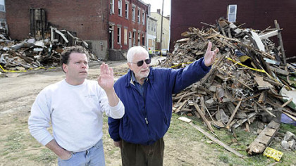 Pitt professor emeritus and meteor expert William Cassidy, right, looks with Matt Grebner toward Mr. Grebner''s Spring Hill home. The site of two destroyed North Side homes is behind Mr. Grebner, who thinks a meteorite may have caused the damage. Dr. Cassidy thinks: unlikely.