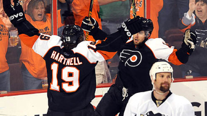 Flyers Joffrey Lupel, against the glass, celebrates his first-period goal.