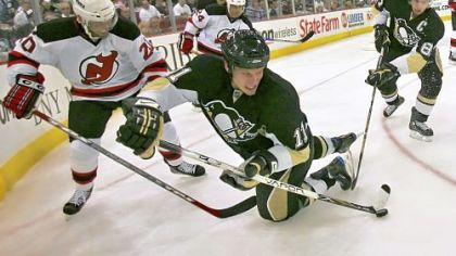 The Penguins' Jordan Staal passes the puck while falling after a collision in Saturday night's game. Staal's contract with the team runs out next summer and the Penguins want to re-sign Staal, but have more pressing concerns right now.