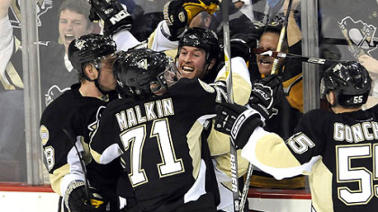 The Penguins' Ryan Malone is smothered by teammates after scoring the winning goal against Ottawa in the third period of Game Two last night at Mellon Arena.