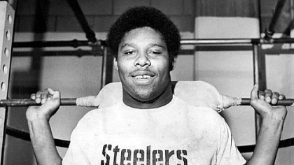 Dwight White "weights" for Dolphins in this '70s photo.