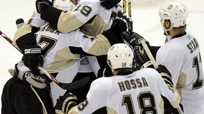 Penguins players celebrate their win in triple overtime against the Red Wings in game 5 of the Stanley Cup Finals in Detroit Monday night.