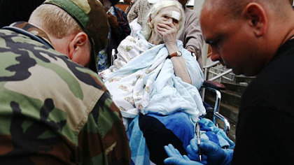 GALVESTON -- A wheelchair-bound Alina Van Epps is evaluated by rescue personnel at Ball High School Sunday.