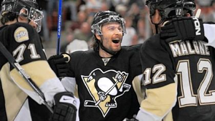 Petr Sykora celebrates his goal against the Lightning with Evgeni Malkin, left, and Ryan Malone in the third period last night at Mellon Arena.