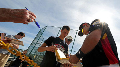 Pirates catcher Ronny Paulino signs autographs for fans during the first day of workouts for pitcher and catchers yesterday at Pirate City in Bradenton, Fla.