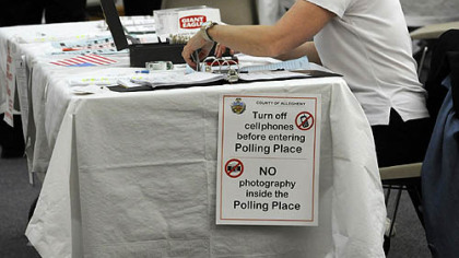 Voters cast ballots this morning at a polling place at the Jewish Community Center in Squirrel Hill.