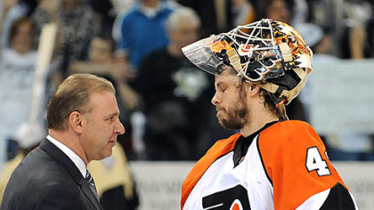 Penguins head coach Michel Therrien shakes hands with Flyers goalie Martin Biron.