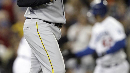 Phil Dumatrait reacts as Los Angeles Dodgers' Jeff Kent rounds the bases after a three-run home run during the fifth inning of their baseball game in Los Angeles last night.