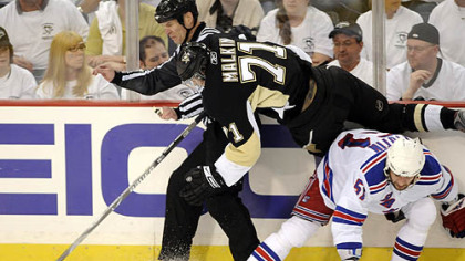 Evgeni Malkin flies over the Rangers' Fedor Tyutin in the third period.